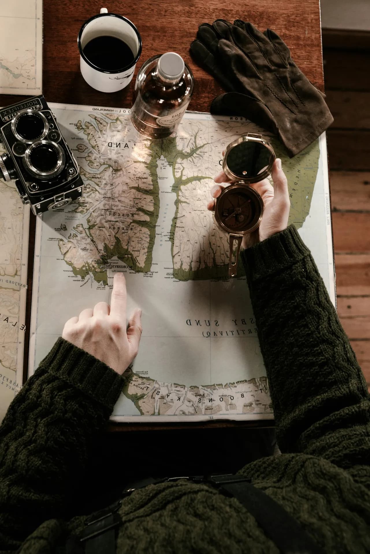 Hunter and host planning the day over maps at a lodge table