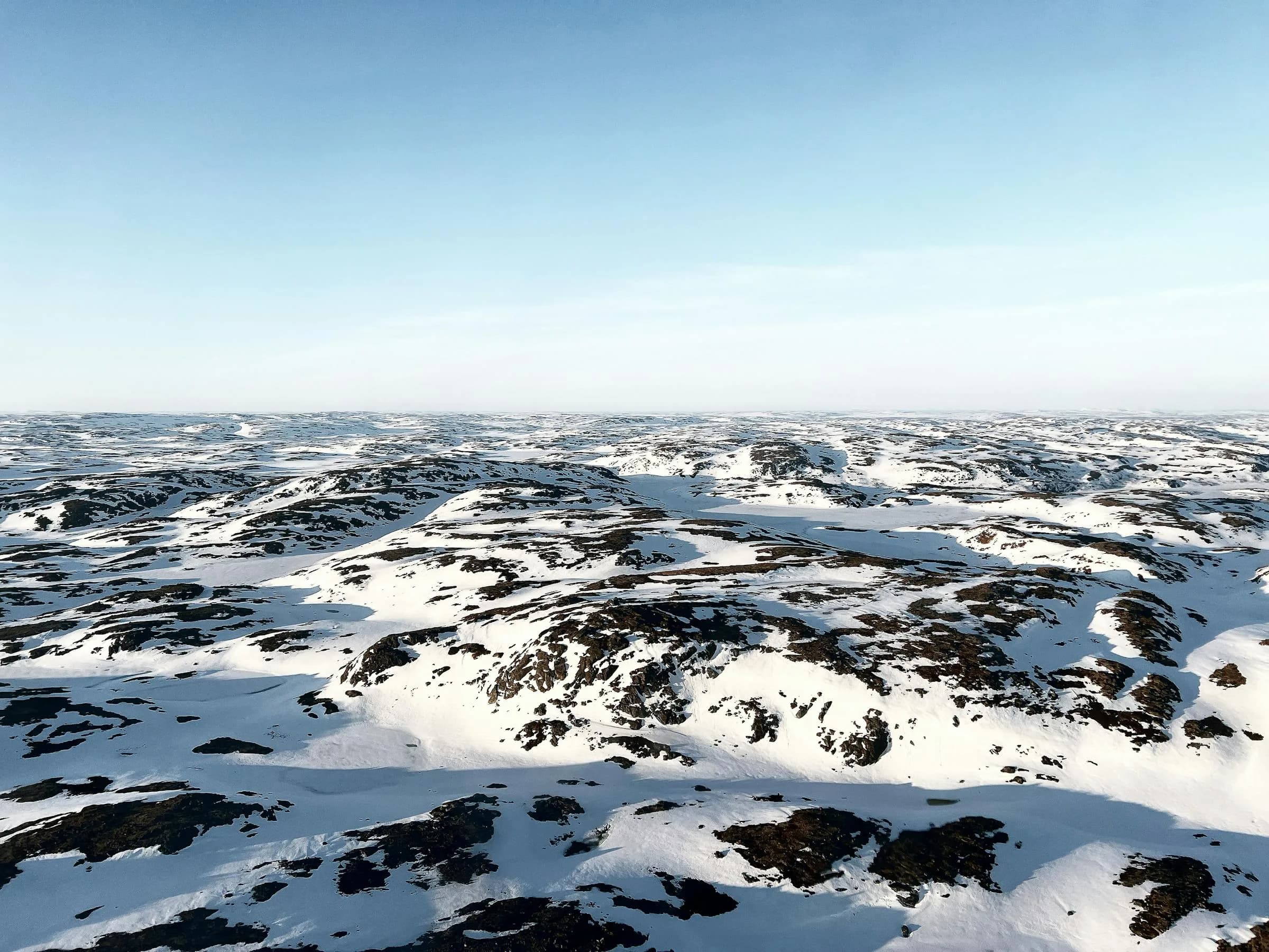 Arctic tundra with snow-covered hills