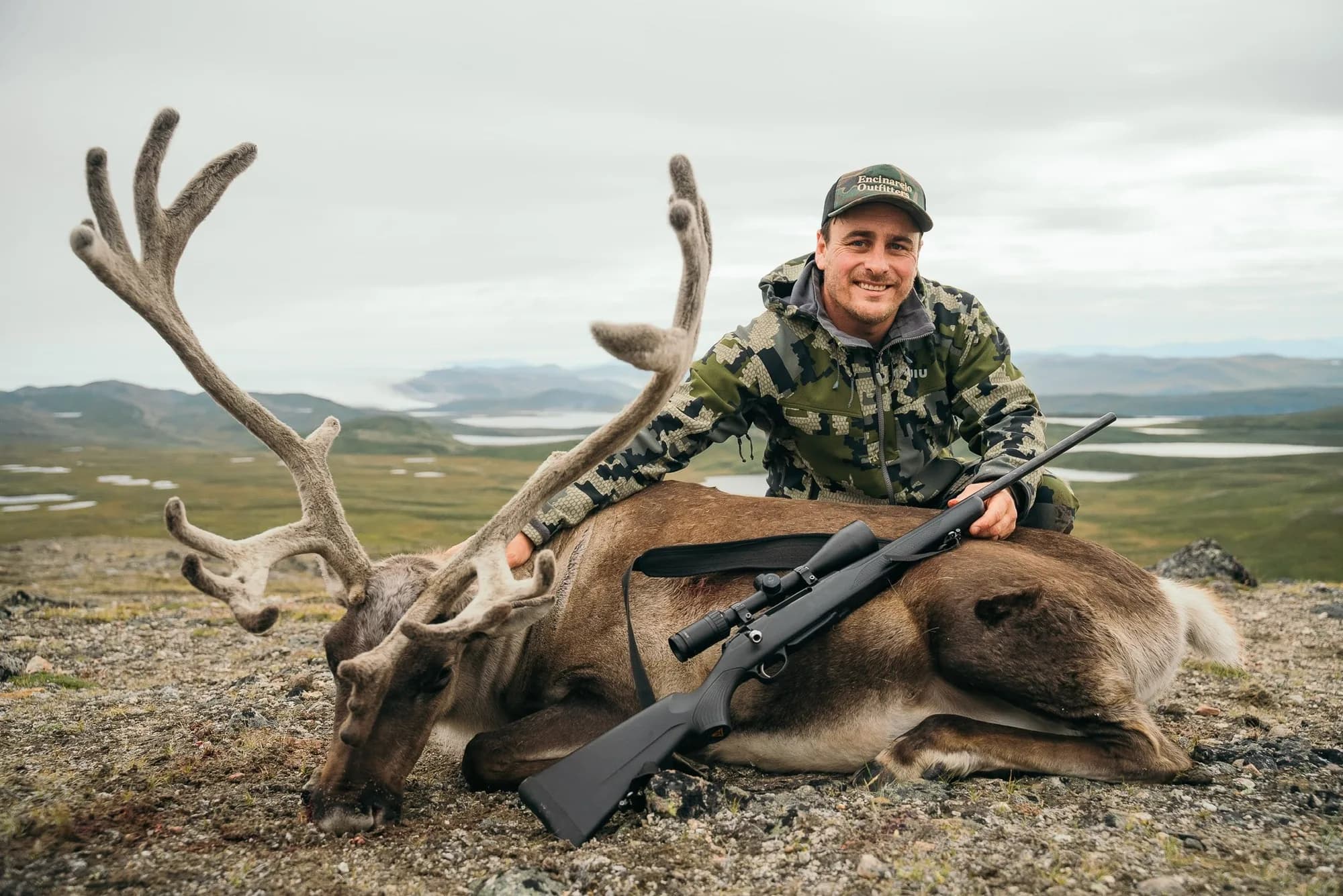 Hunter with a Greenland caribou on the tundra