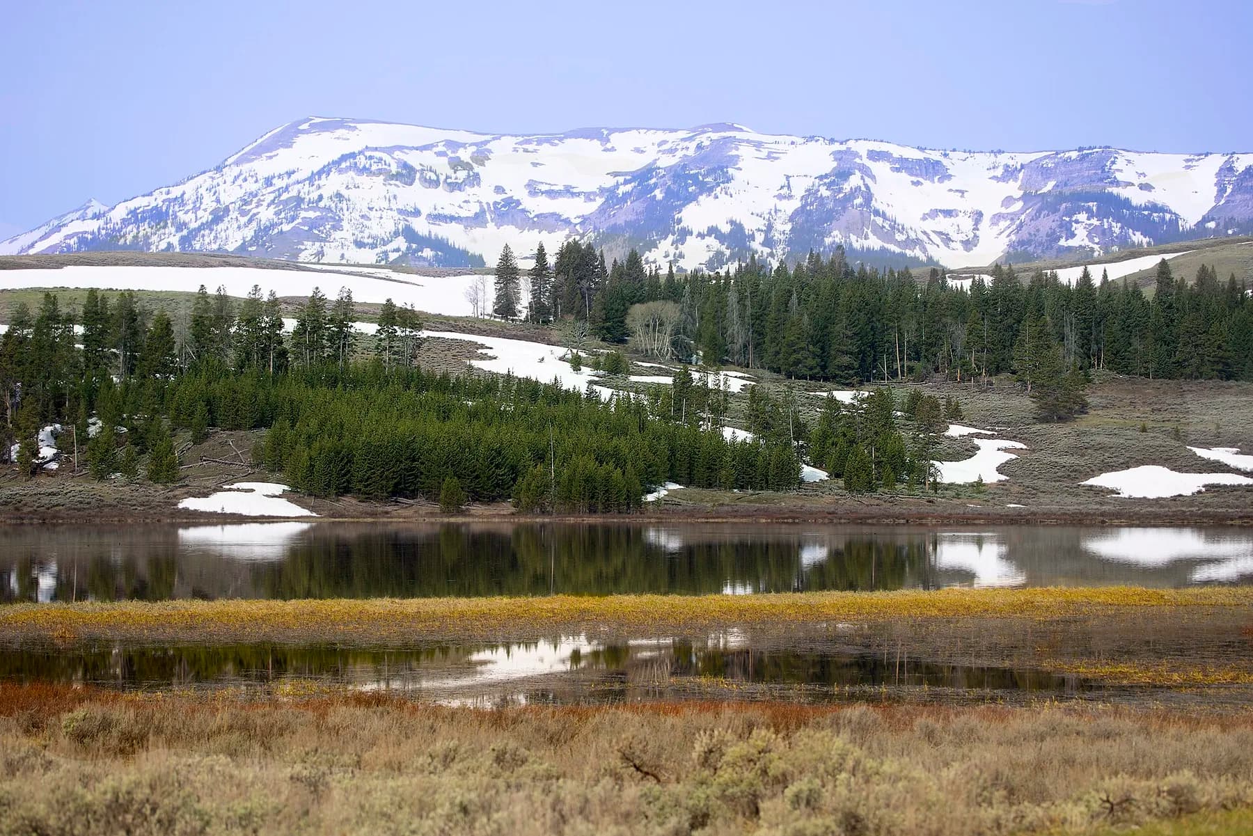 Snow lying in a high meadow under the peaks