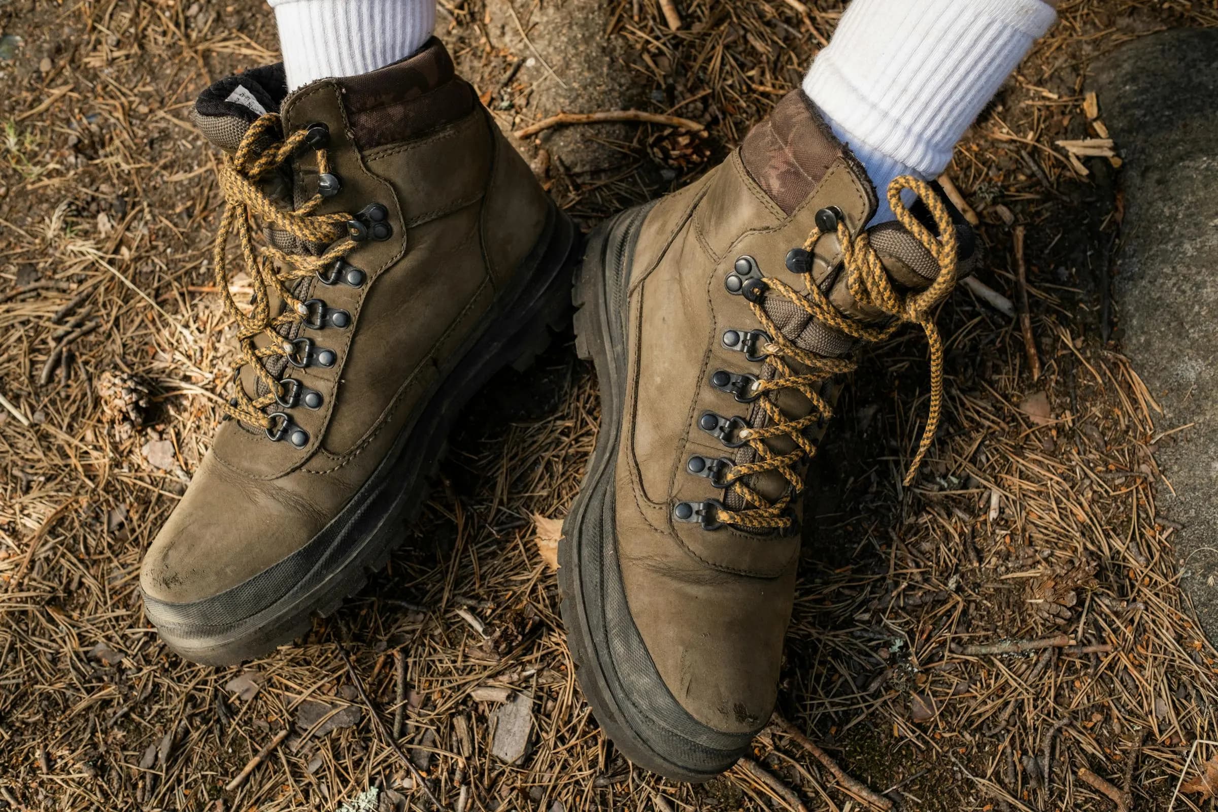 Worn hiking boots on terrain — Approved Ground is walked, not assumed