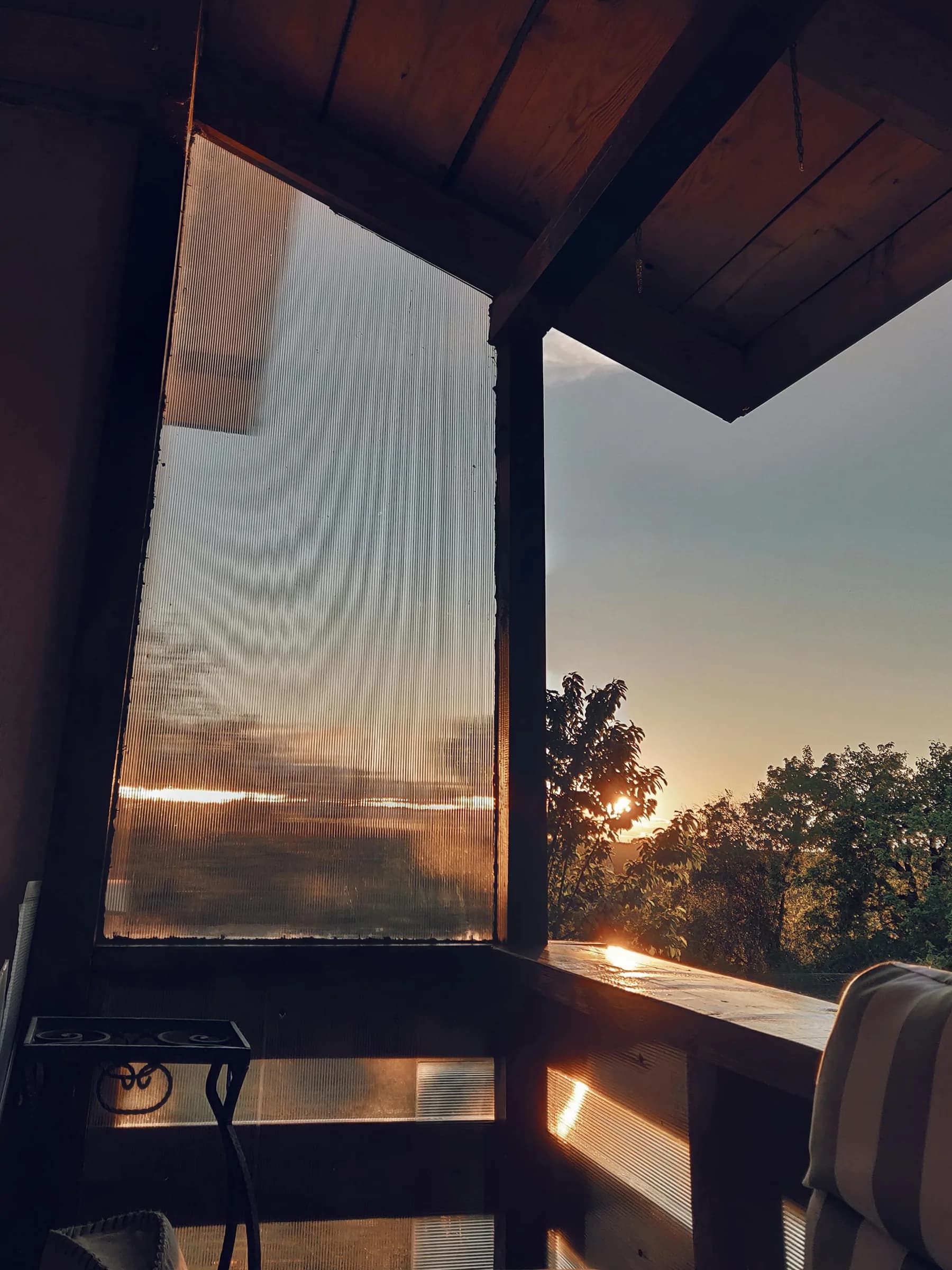 Lodge veranda at sunset — the difference is on the ground