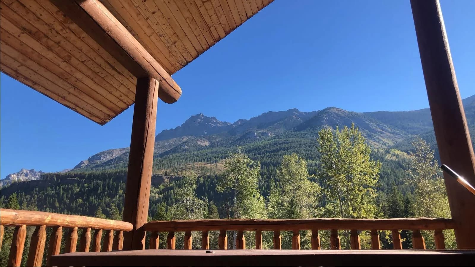The outpost lodge deck under the peaks