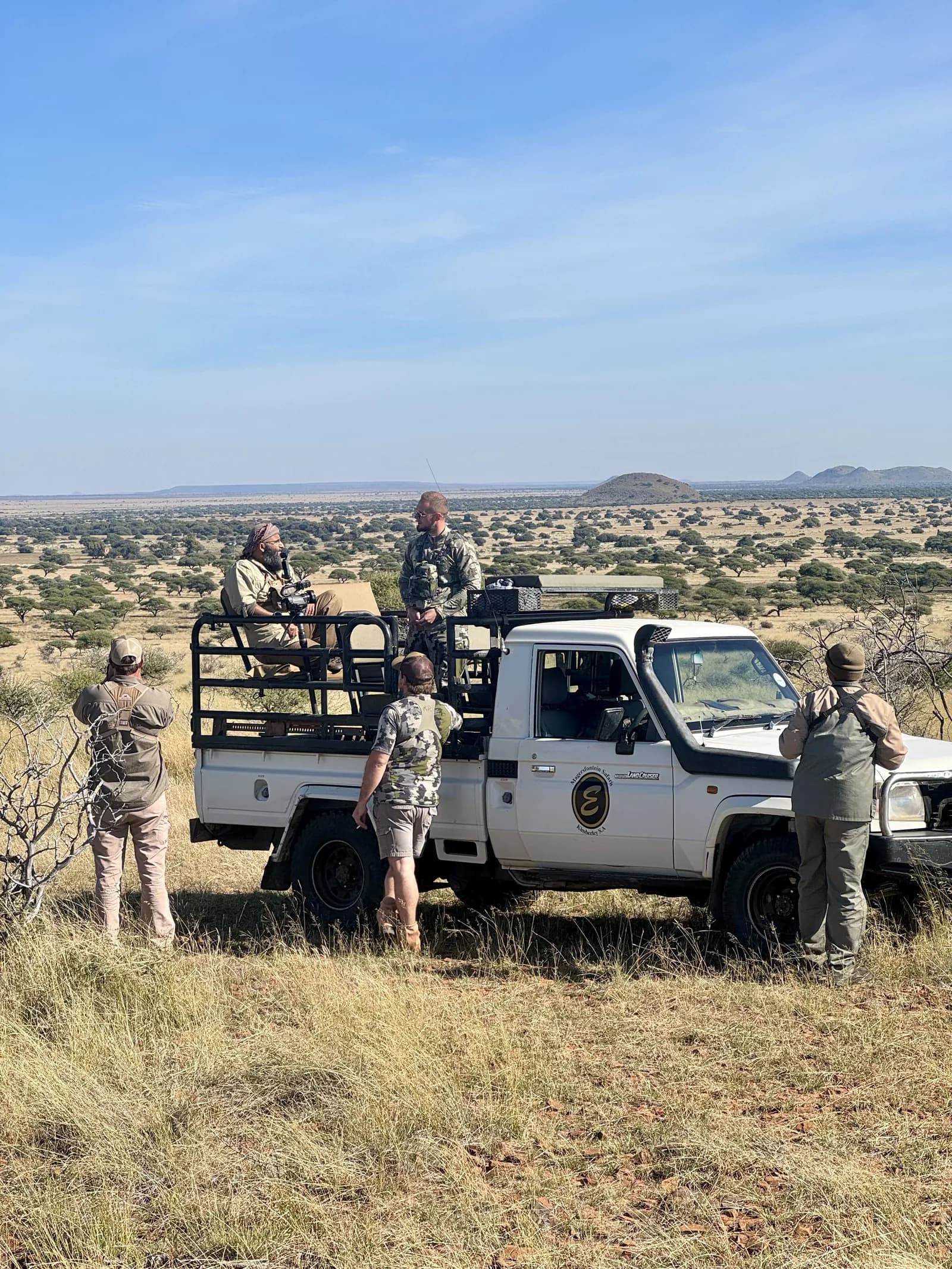 Hunters glassing the Kalahari flats from the cruiser