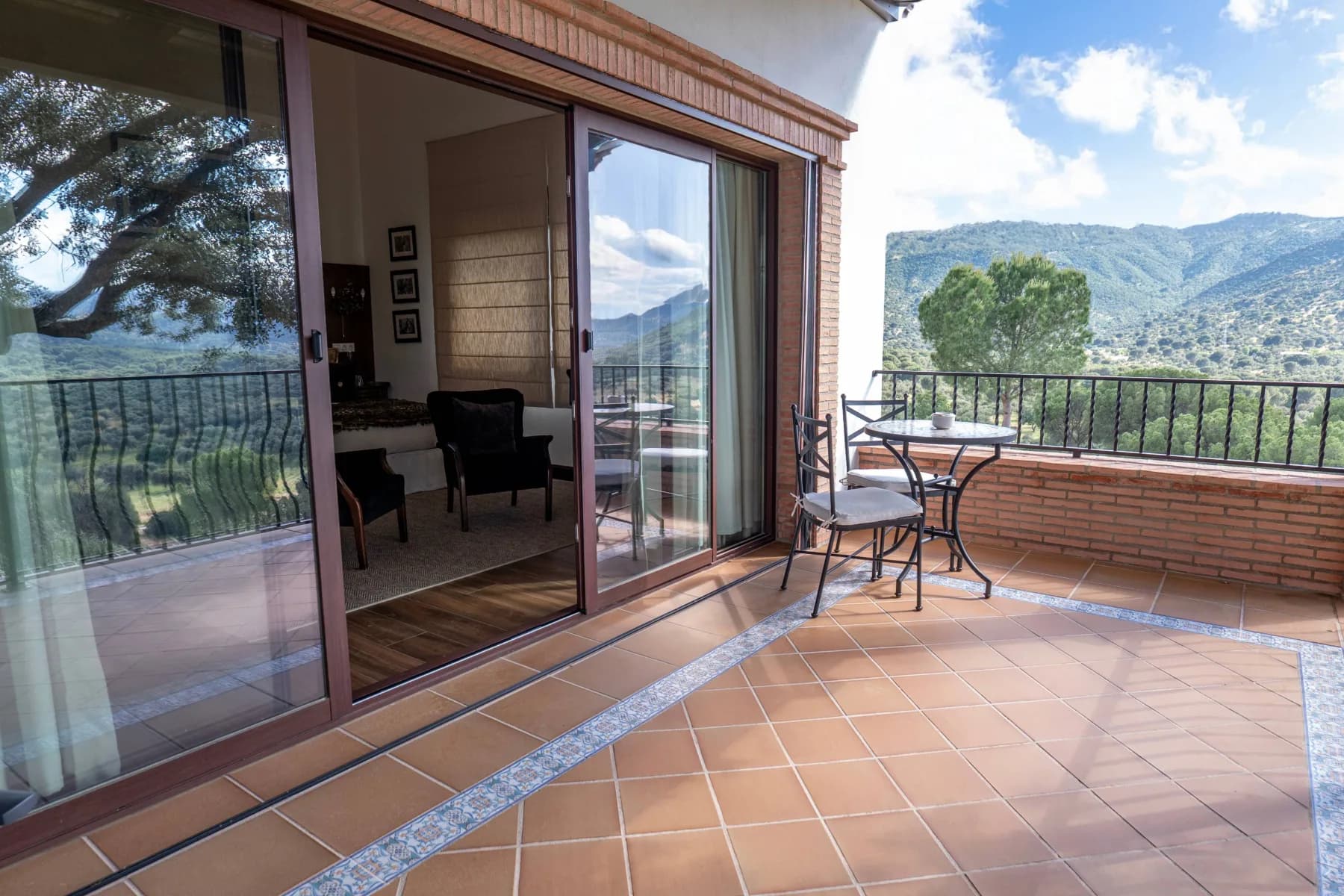 Sliding doors open from the lodge onto the tiled terrace and its valley view