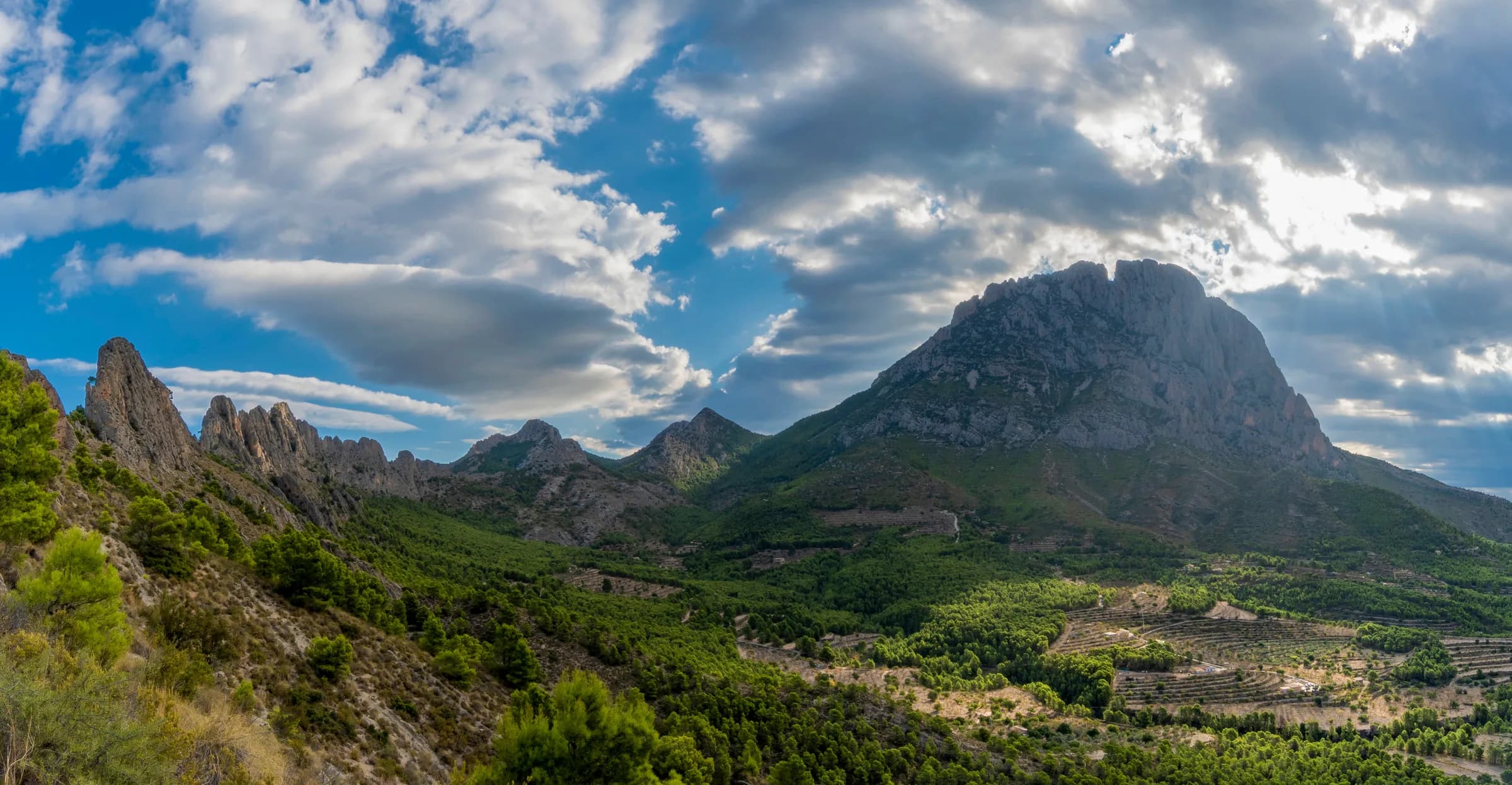 The jagged limestone massif above a green Spanish valley